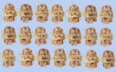 Toasted bread with ham, yellow cheese and flax seeds with a green, purple and blue background.