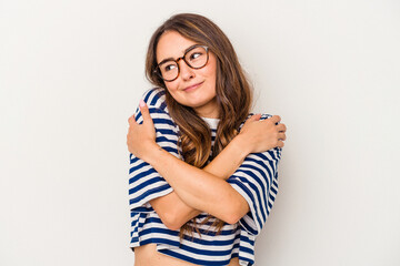 Young caucasian woman isolated on white background hugs, smiling carefree and happy.