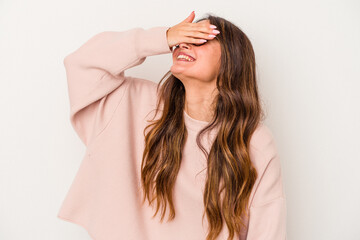 Fototapeta premium Young caucasian woman isolated on white background laughs joyfully keeping hands on head. Happiness concept.