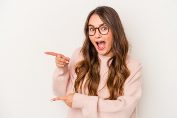 Young caucasian woman isolated on white background excited pointing with forefingers away.