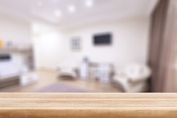 The wooden empty table in front of the room interior. For product display and presentation
