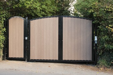 Newley installed modern residential wooden and metal electric security gates with keypad
- 458036220