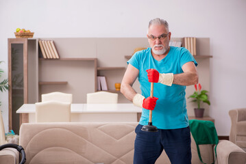 Old man doing plumbing at home