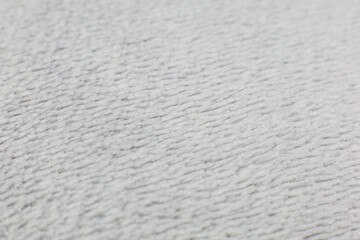 Grey cotton towel or carpet.fluffy texture background. Close up, macro photo. Soft focus image.
