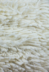 White cotton towel or carpet.fluffy texture background. Close up, macro photo. Soft focus image.