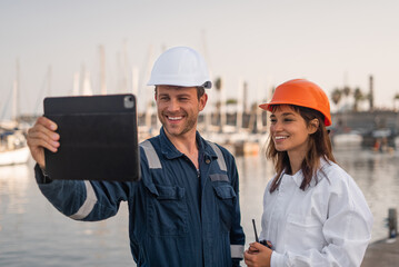 Cheerful port employees with tablet