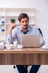 Young male employee rejecting new ideas in the office