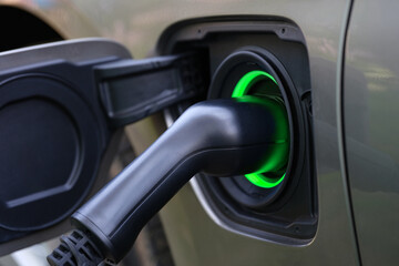 Electric car and charging at charging station closeup