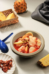 Asinan Buah Bogor, Fruit Pickle Made from Sliced Fresh Tropical Fruits On Sweet, Sour and Spicy Red Soup. Topped with Fried Peanuts Famous during Ramadhan.