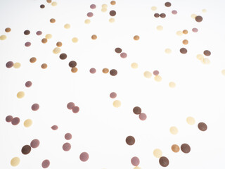 Multicolored chocolate granules scattered on white background