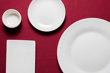 赤い布の上に置かれた複数の白いの皿