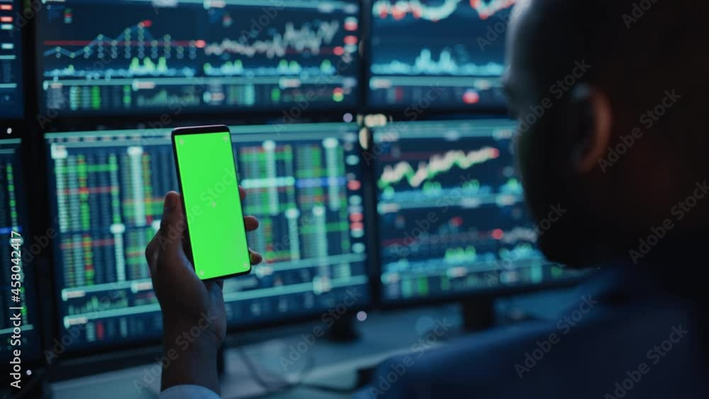 Aufkleber financial analyst using smartphone with green screen chroma key mock up template and working on mult