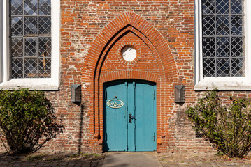 Ancient church door of the Lutheran St. Laurentius Church  (1200 AD) at Toenning, Germany. The sign...