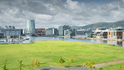 Elevated view on Belfast city quays, harbour and marina with tall modern buildings in the background, UK, Northern Ireland - obrazy, fototapety, plakaty