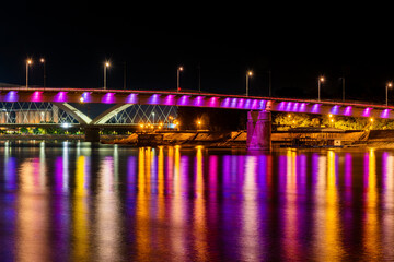 Fototapeta na wymiar Novi Sad, Serbia August 24, 2021: Rainbow bridge, Novi Sad, Serbia. Night reflection in Novi Sad