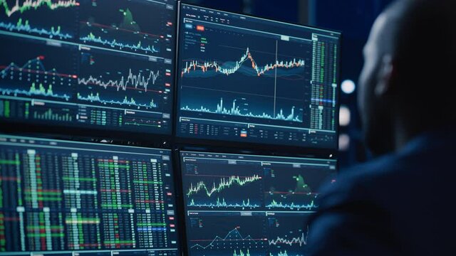 Close Up Portrait of Financial Analyst Working on Computer with Multi-Monitor Workstation with Real-Time Stocks, Commodities and Exchange Market Charts. Businesswoman at Work in Investment Agency.