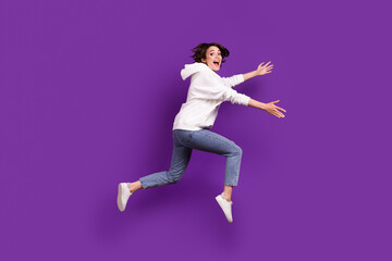 Full size profile side photo of young excited smiling female running in air catch hold product isolated on violet color background
