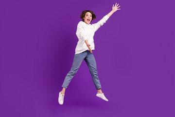 Fototapeta na wymiar Full size photo of good mood funky funny girl jumping catch product advertisement isolated on violet color background