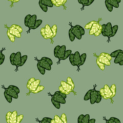 Seamless pattern bunch spinach salad on pastel green background. Modern ornament with lettuce.