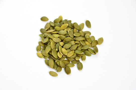green pumpkin seeds isolated on white background, close-up