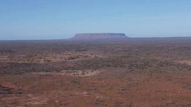 a morning aerial shot flying forward towards mt conner in the northern territory of australia