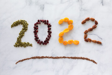 Top down view of healthy ingredients forming the numbers 2022. New Year concept.