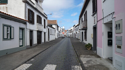 Fototapeta na wymiar deserted cobblestone road in the old town with traditional houses, Horta, Azores