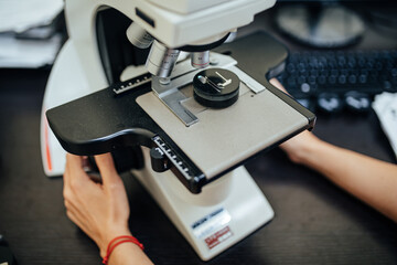Working with a microscope in a factory for producing parts for airplane engines. Industrial concept.