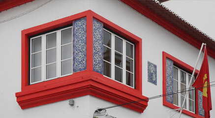 corner window with red frame decorated with traditional painted tiles, Praia da Vitoria, Azores 