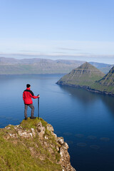 Fototapeta na wymiar Hiker in hike on Eysturoy island overlooking the Funningur fjord, Faroe Islands