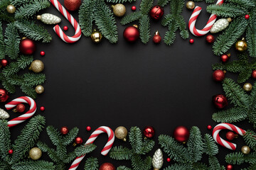 Christmas ornaments frame with fir branches on a black background