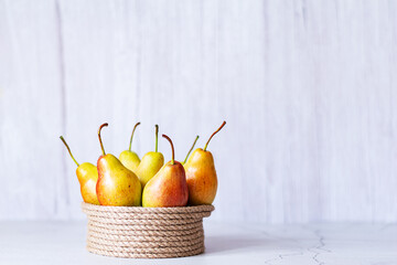 Basket with fresh pears on the table