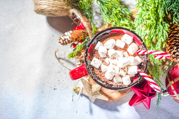 Homemade hot chocolate with mini marshmallows, hot cozy Christmas cocoa drink on wooden background with Xmas decorations copy space