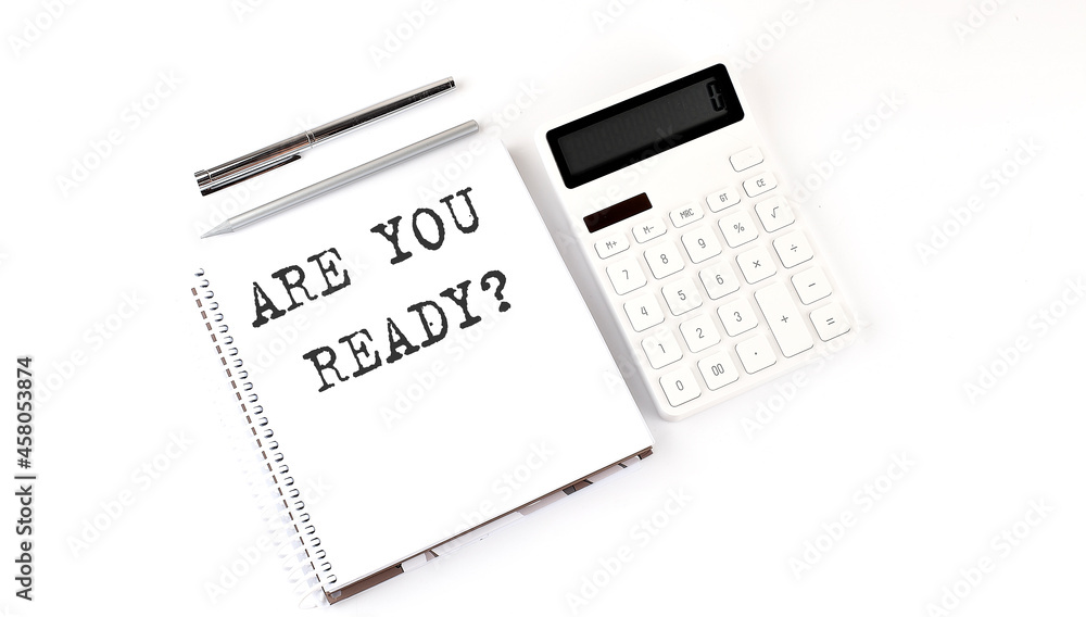 Poster notepad with text are you ready with calculator and pen. white background. business concept