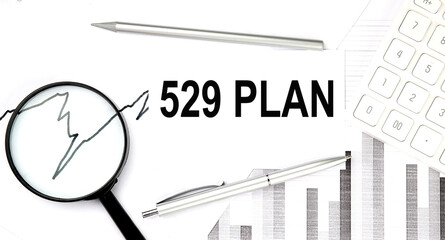 529 PLAN text on document with pen,graph and magnifier,calculator