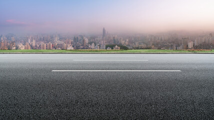 Panoramic skyline and empty asphalt road with modern buildings