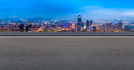 Panoramic skyline and empty asphalt road with modern buildings
