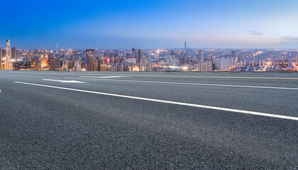 Panoramic skyline and empty asphalt road with modern buildings