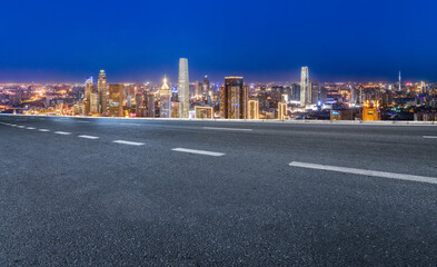 Panoramic skyline and empty asphalt road with modern buildings