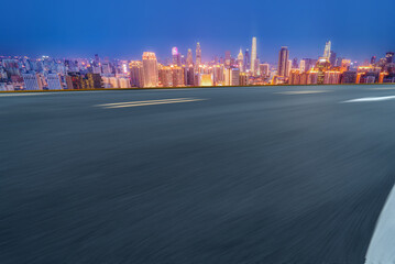 Panoramic skyline and empty asphalt road with modern buildings