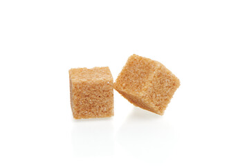 Two brown cubes of cane sugar isolated on white background. Close up view.