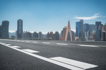 Panoramic skyline and empty asphalt road with modern buildings