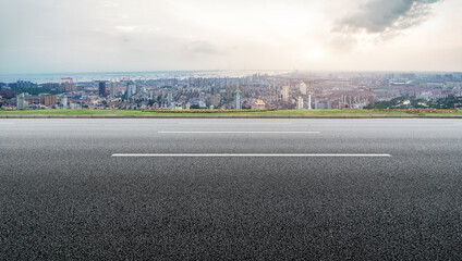 Panoramic skyline and empty asphalt road with modern buildings