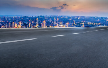 Fototapeta premium Panoramic skyline and empty asphalt road with modern buildings