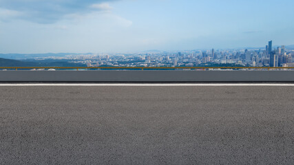 Panoramic skyline and empty asphalt road with modern buildings
