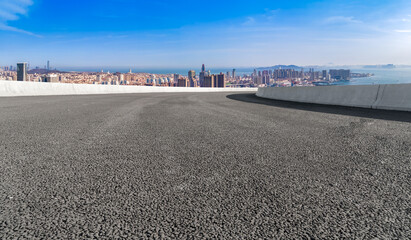 Panoramic skyline and empty asphalt road with modern buildings