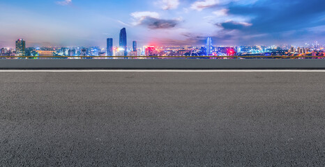 Plakat Panoramic skyline and empty asphalt road with modern buildings
