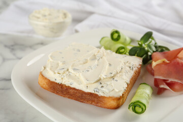 Delicious sandwich with cream cheese, cucumber and jamon on plate, closeup