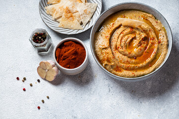 Traditional arabian eggplant dip baba ganoush with herbs and smoked paprika on light background. Eggplant hummus. Babaganush or eggplant caviar. Baked eggplant. Turkish eggplant dip