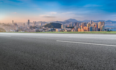 Panoramic skyline and empty asphalt road with modern buildings